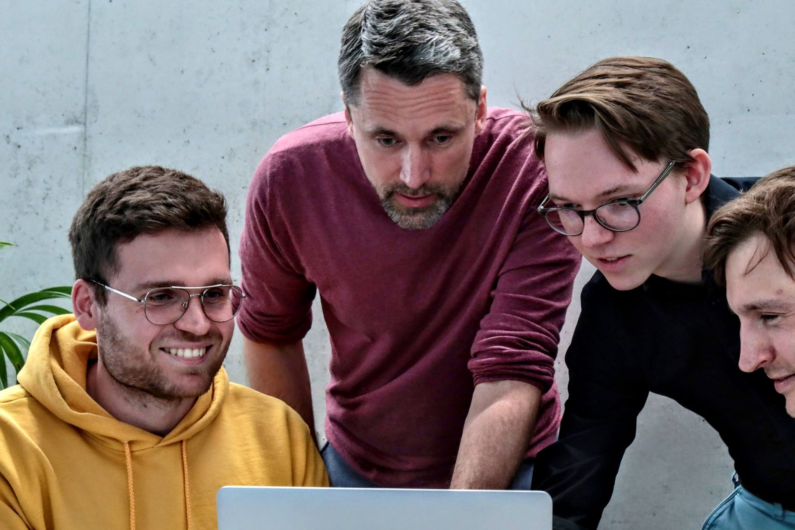 CIATA team members gathered around a laptop, collaborating on a project